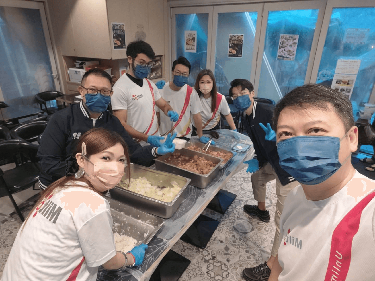 Milton volunteers serving rice and dishes at Grandma's Kitchen